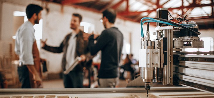 CNC Router acquired through financing with business men in the background -  pexels-helena-lopes-3688760