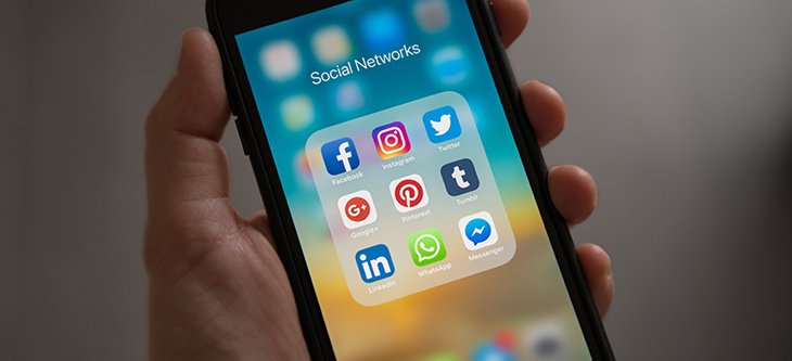 A mobile phone screen displaying social media apps as essential tools for digital marketing -  pexels-tracy-le-blanc-607812