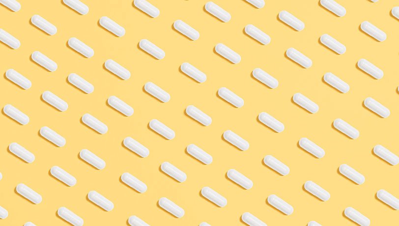 A pattern of diagonal lines built from medicine pills against a yellow background.